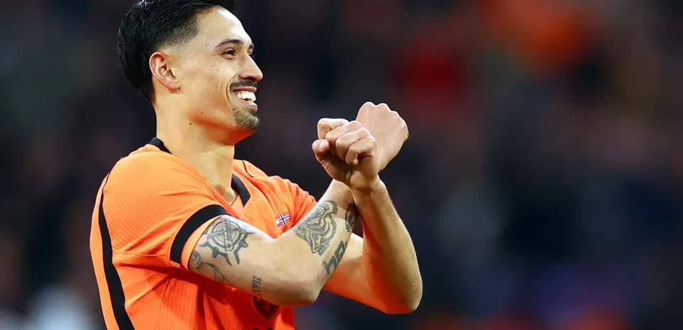 Player celebrating in orange jersey during match