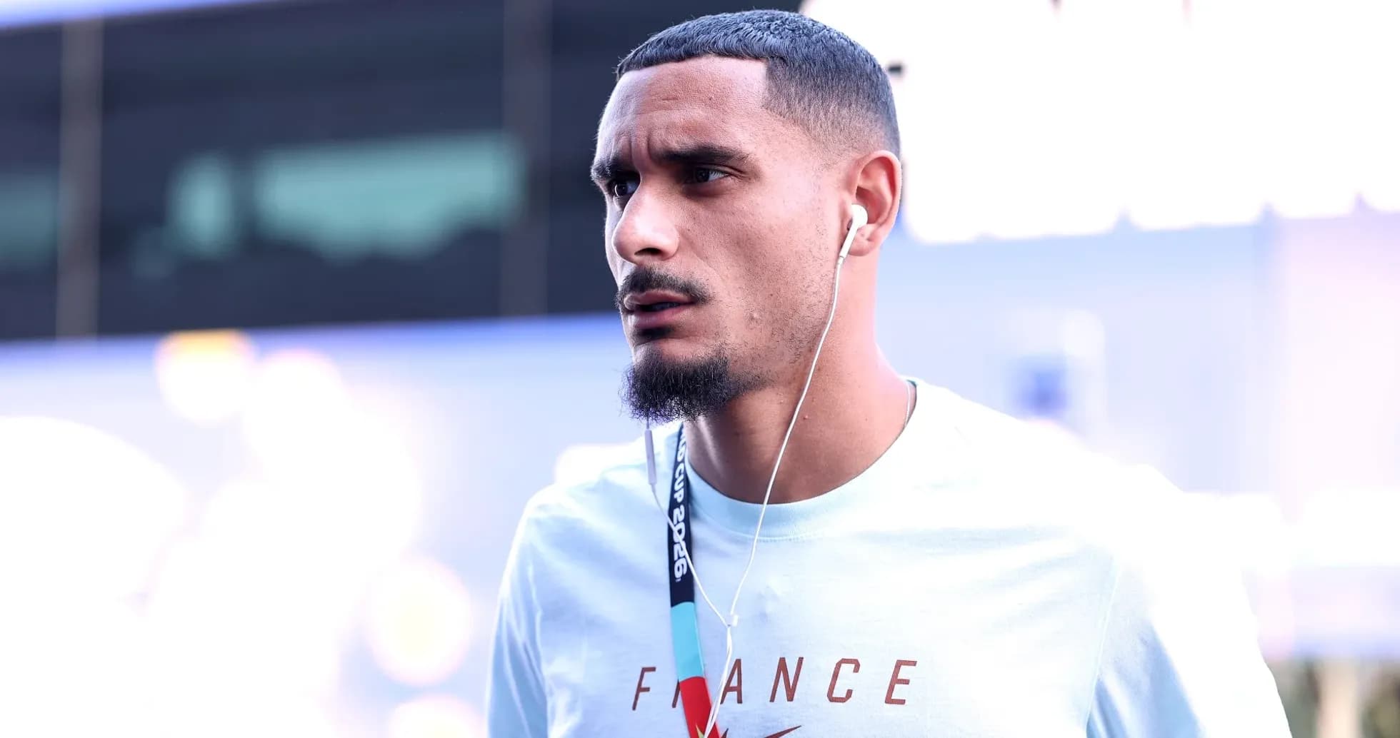 Player wearing headphones walking in casual attire