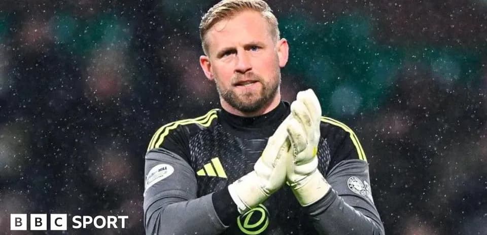 Goalkeeper clapping hands during snowy match