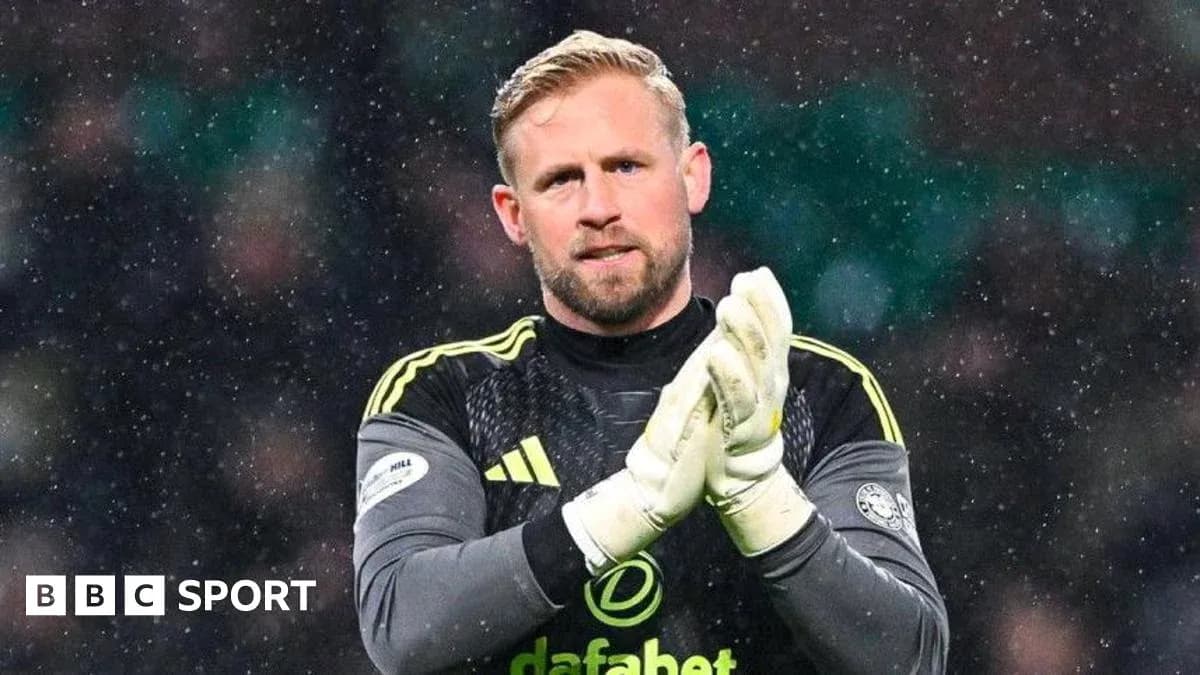 Goalkeeper clapping hands during snowy match