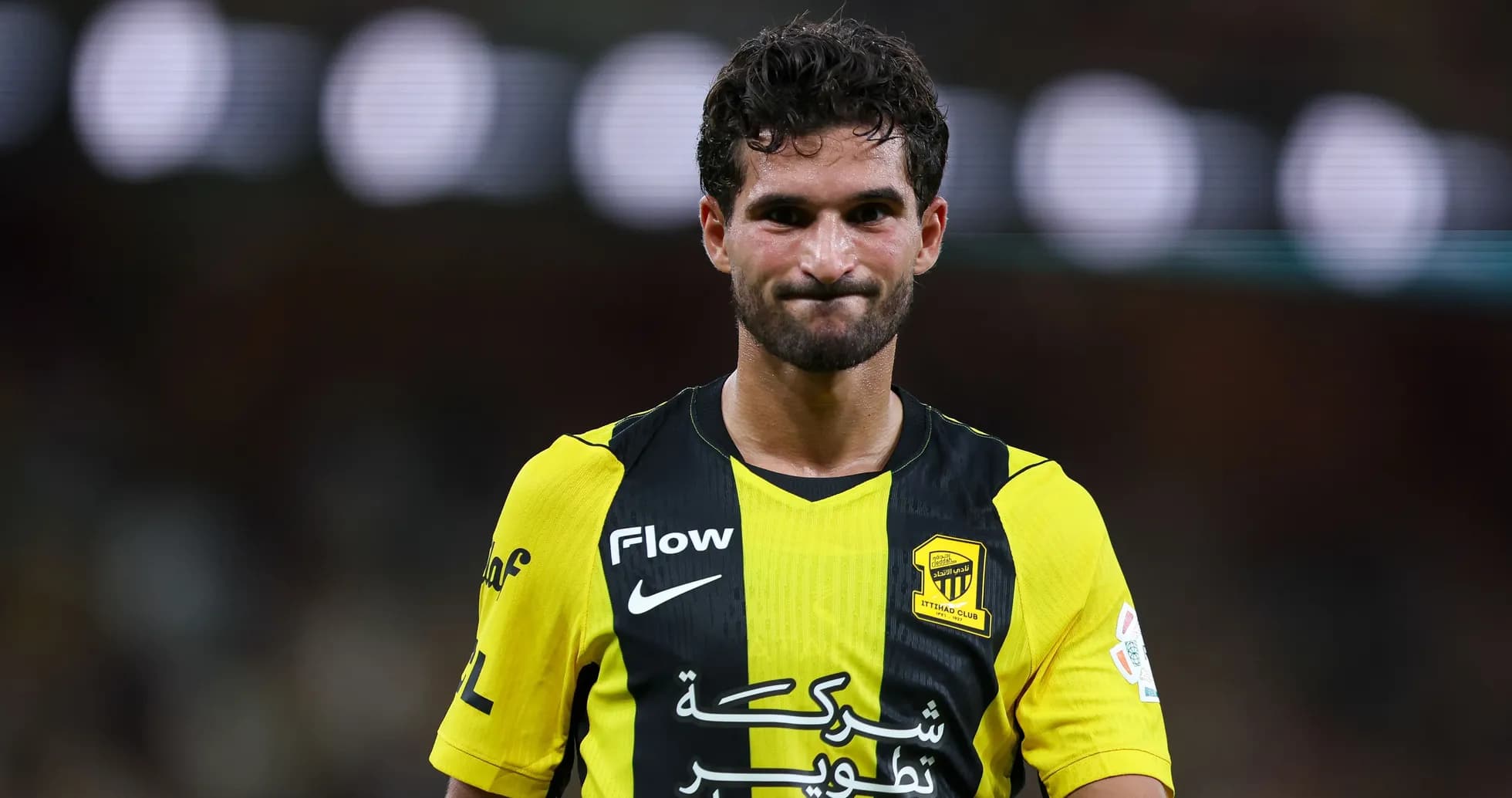 Player in yellow and black jersey during match