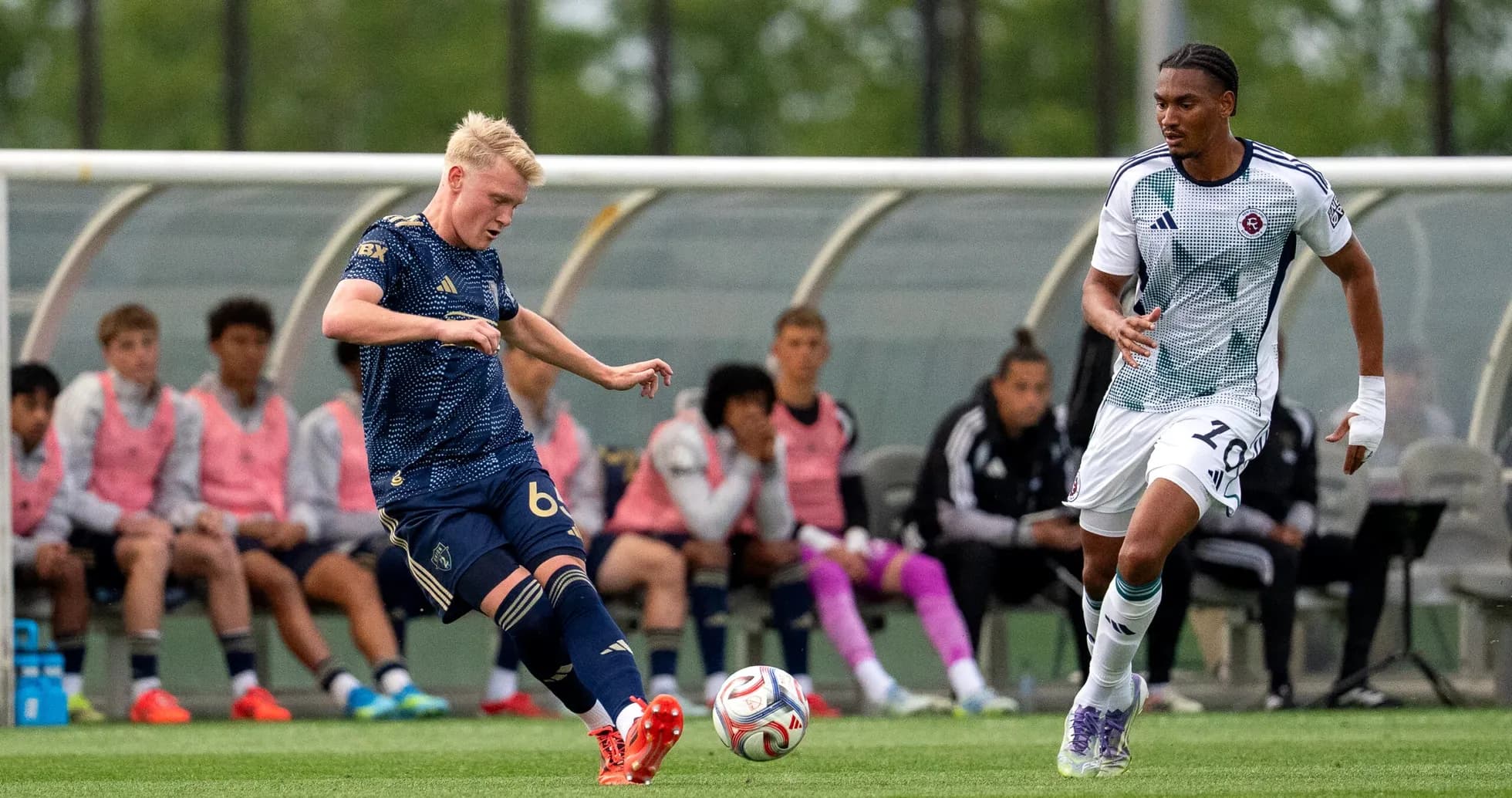 Player kicking the ball during New England II match