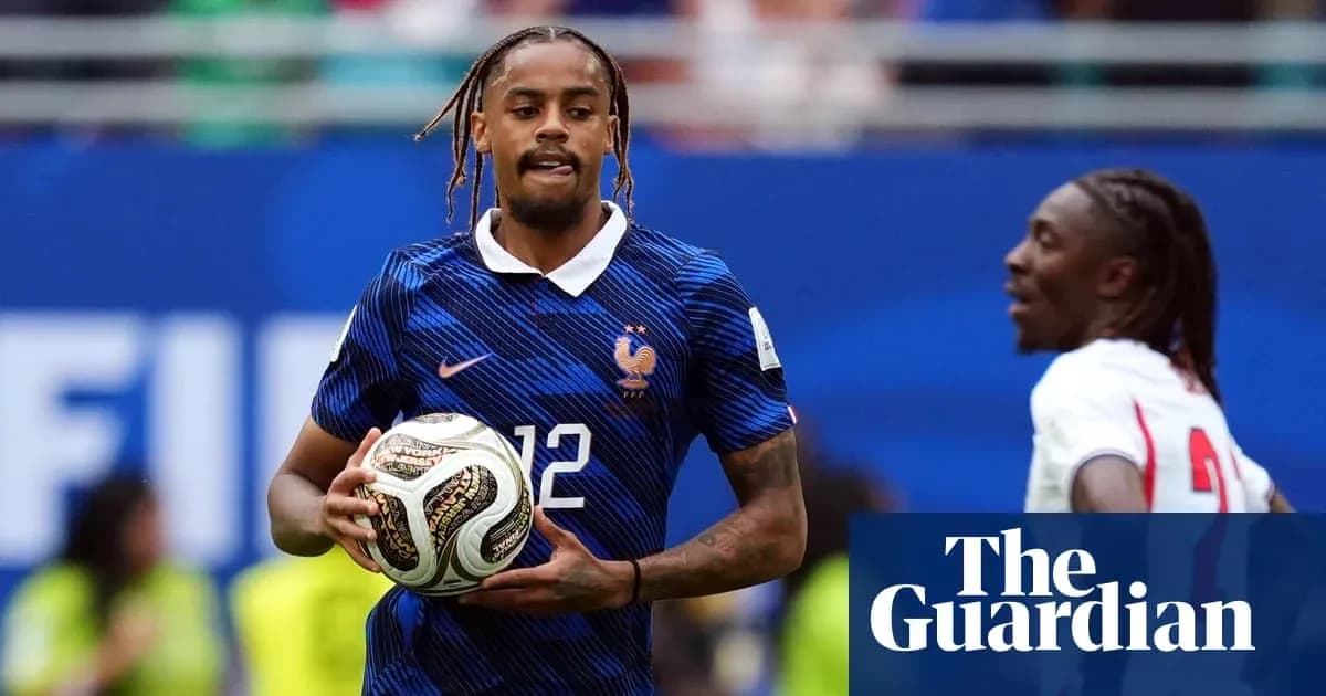 Player in blue France kit holding a soccer ball