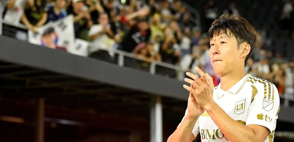Player applauding fans during match at stadium