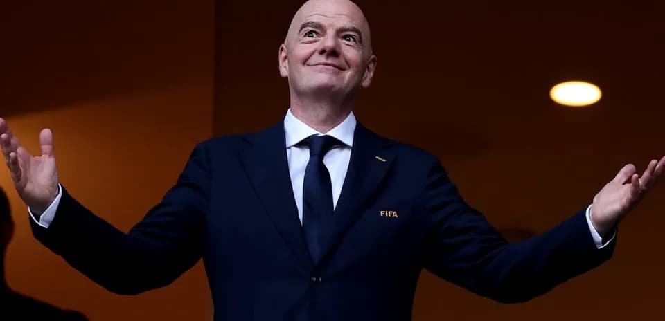 FIFA president gesturing from a balcony