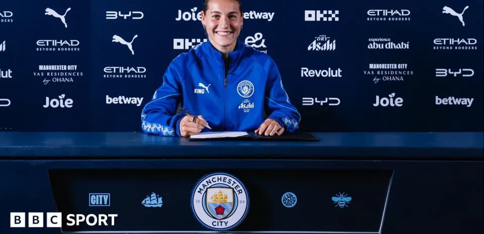 Player signing contract at Manchester City press table