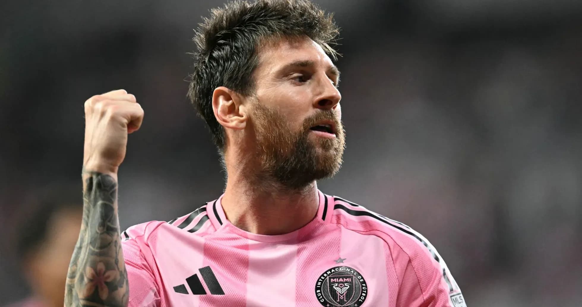 Player celebrating in pink Miami jersey during match
