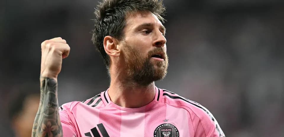 Player celebrating in pink Miami jersey during match