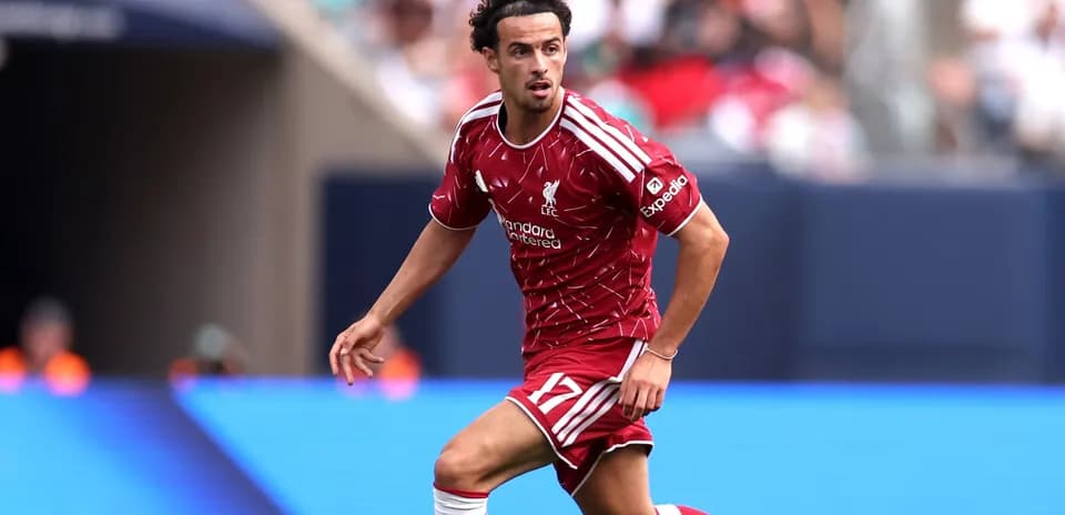 Player in red Liverpool kit running on the pitch