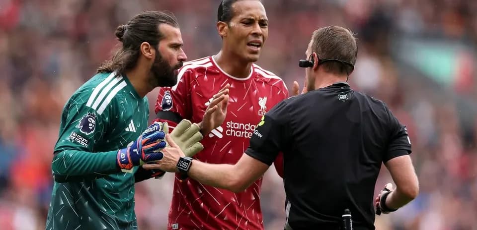 Liverpool players arguing with the referee during match