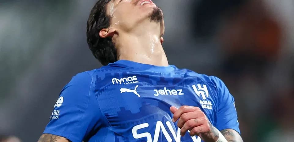 Player in blue jersey expressing frustration during match