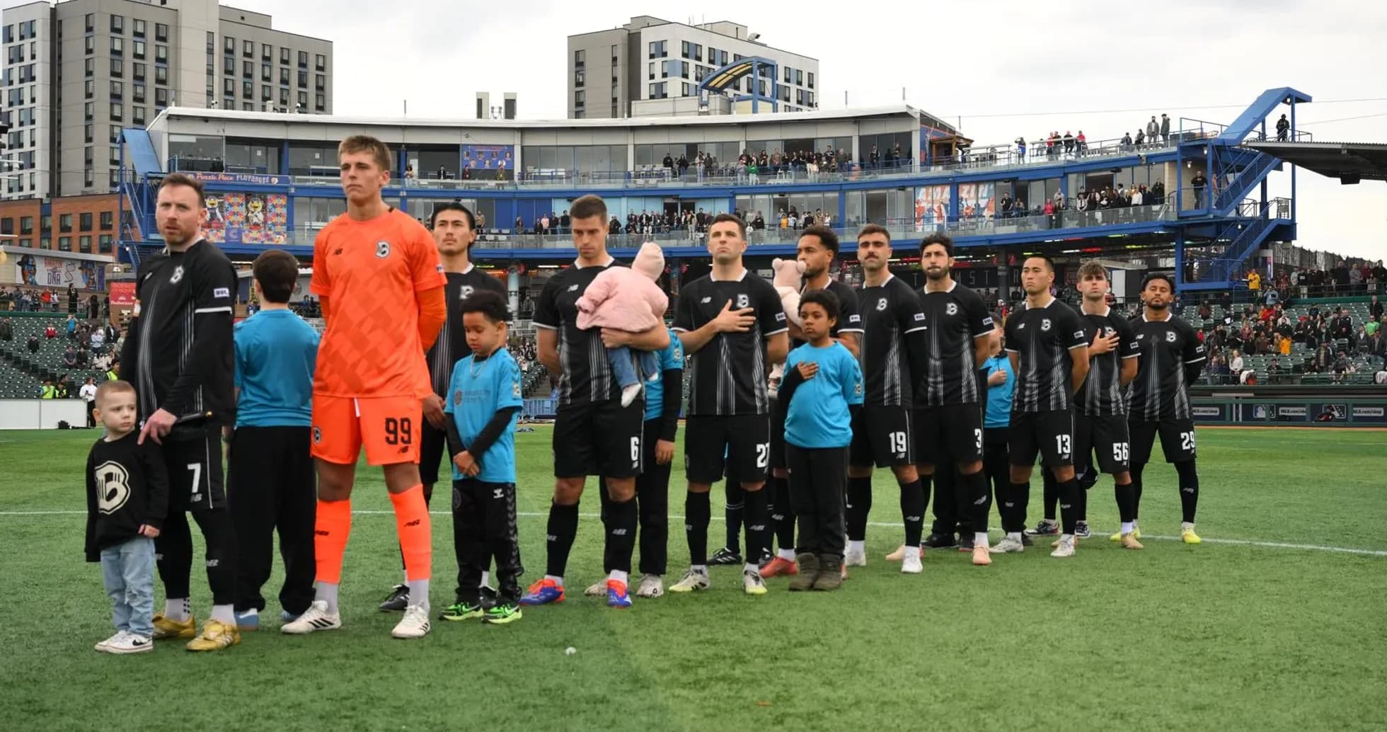 Players lined up before the match at stadium