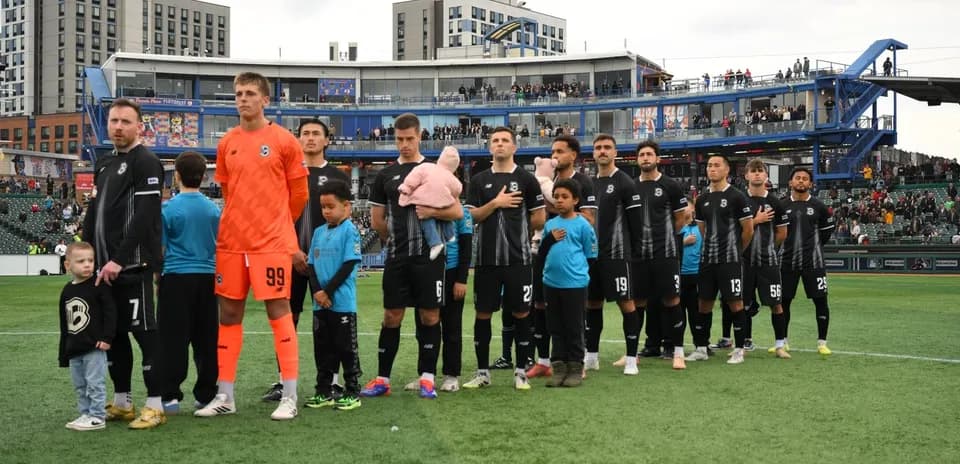 Players lined up before the match at stadium