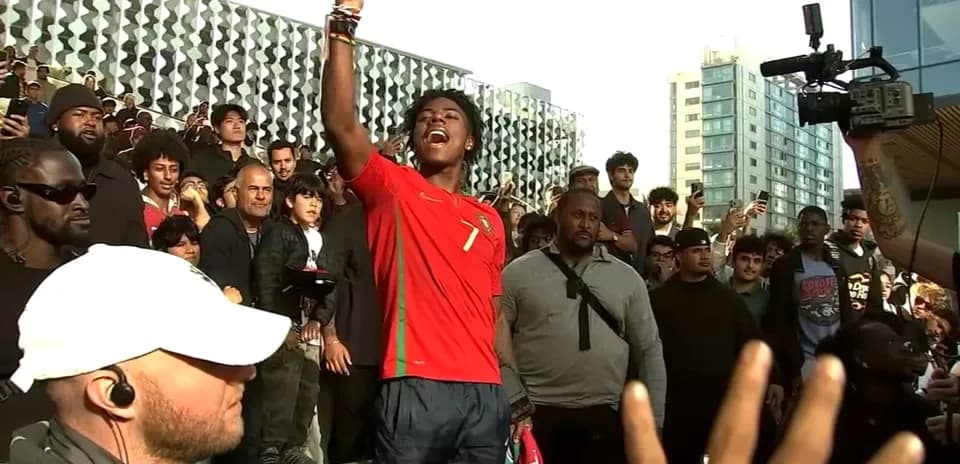 Fan in Portugal jersey celebrating with crowd