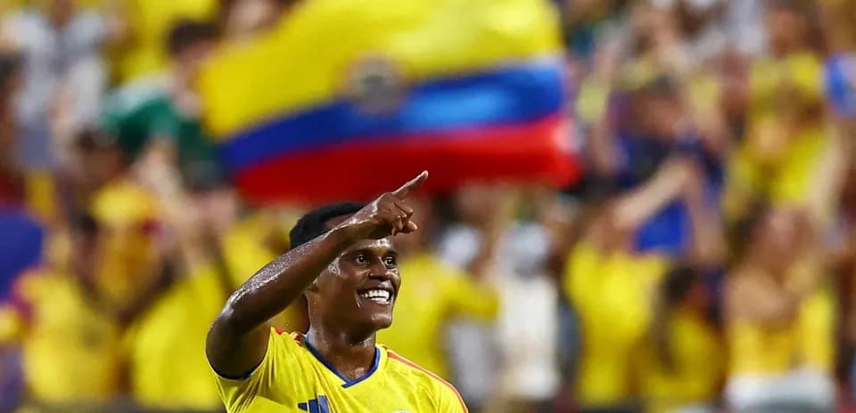 Colombian player celebrating in front of fans