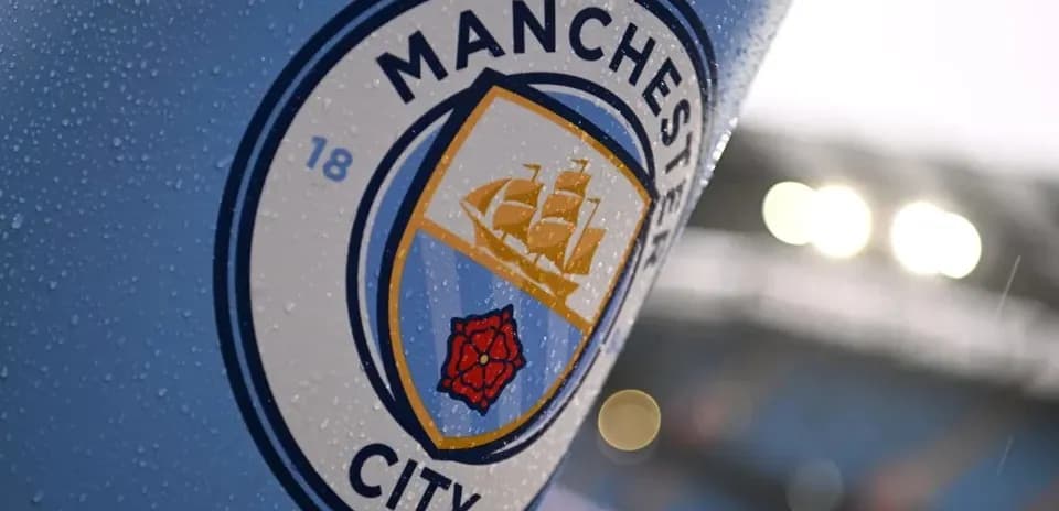 Close-up of Manchester City club logo with rain