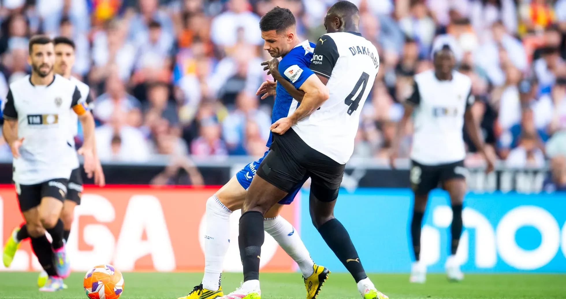Athletic Club player challenged by Valencia defender
