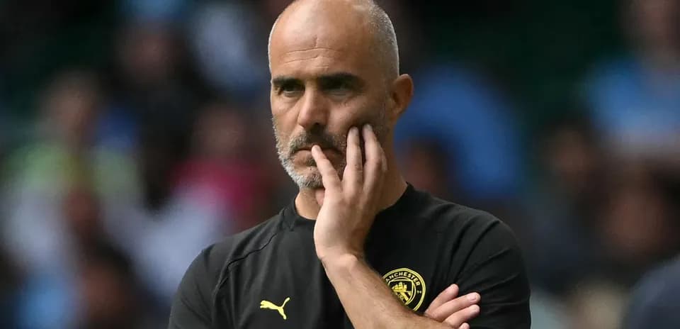 Coach with hand on chin during match observation