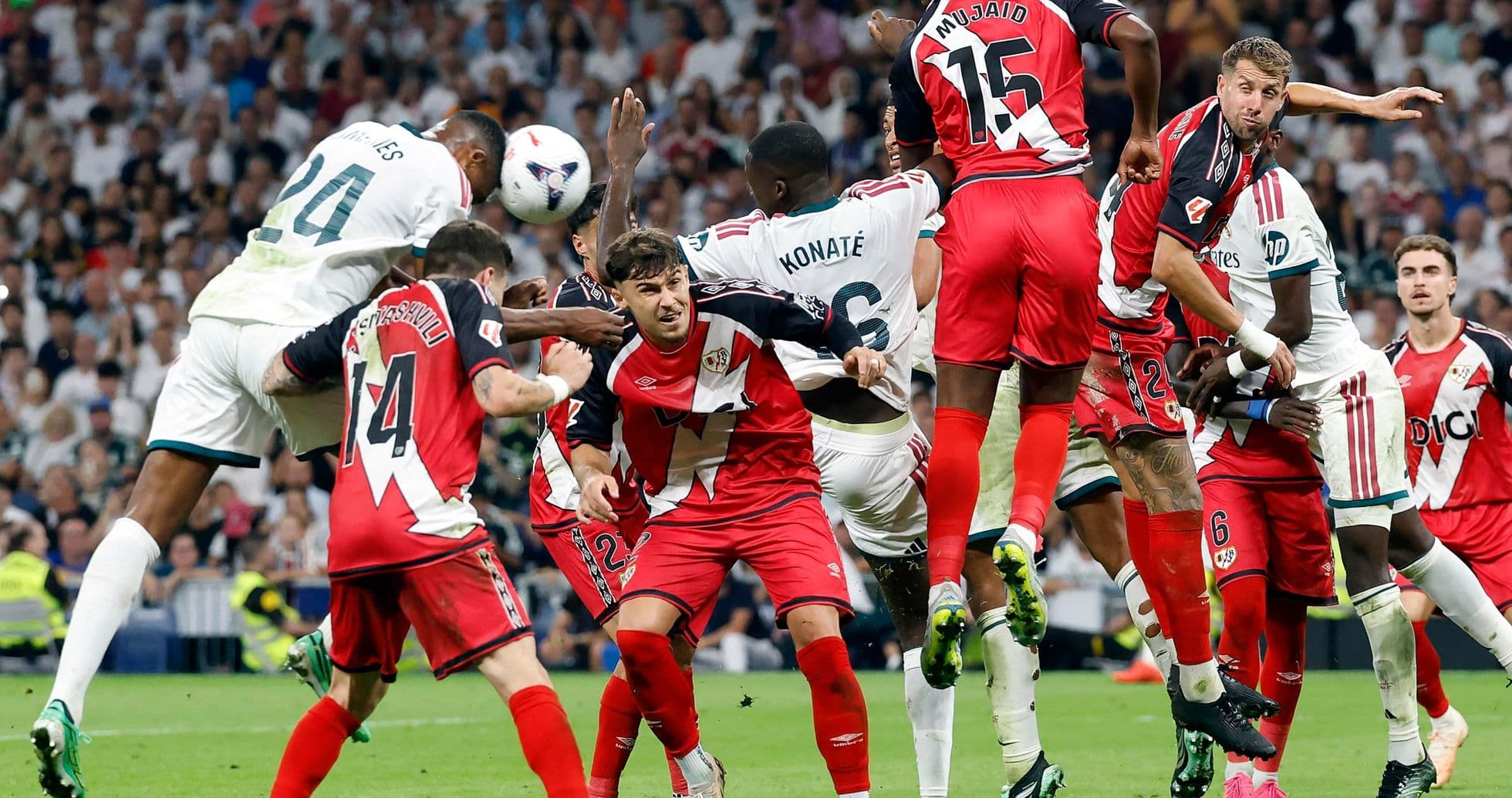 Players contesting a corner kick during match
