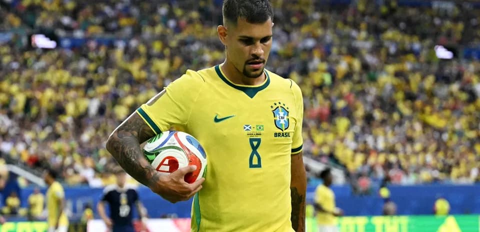 Player in Brazil jersey holding a soccer ball