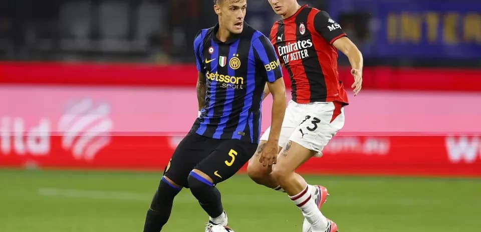 Two players battling for the ball on the field