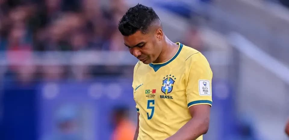 Brazilian player walking with head down on field