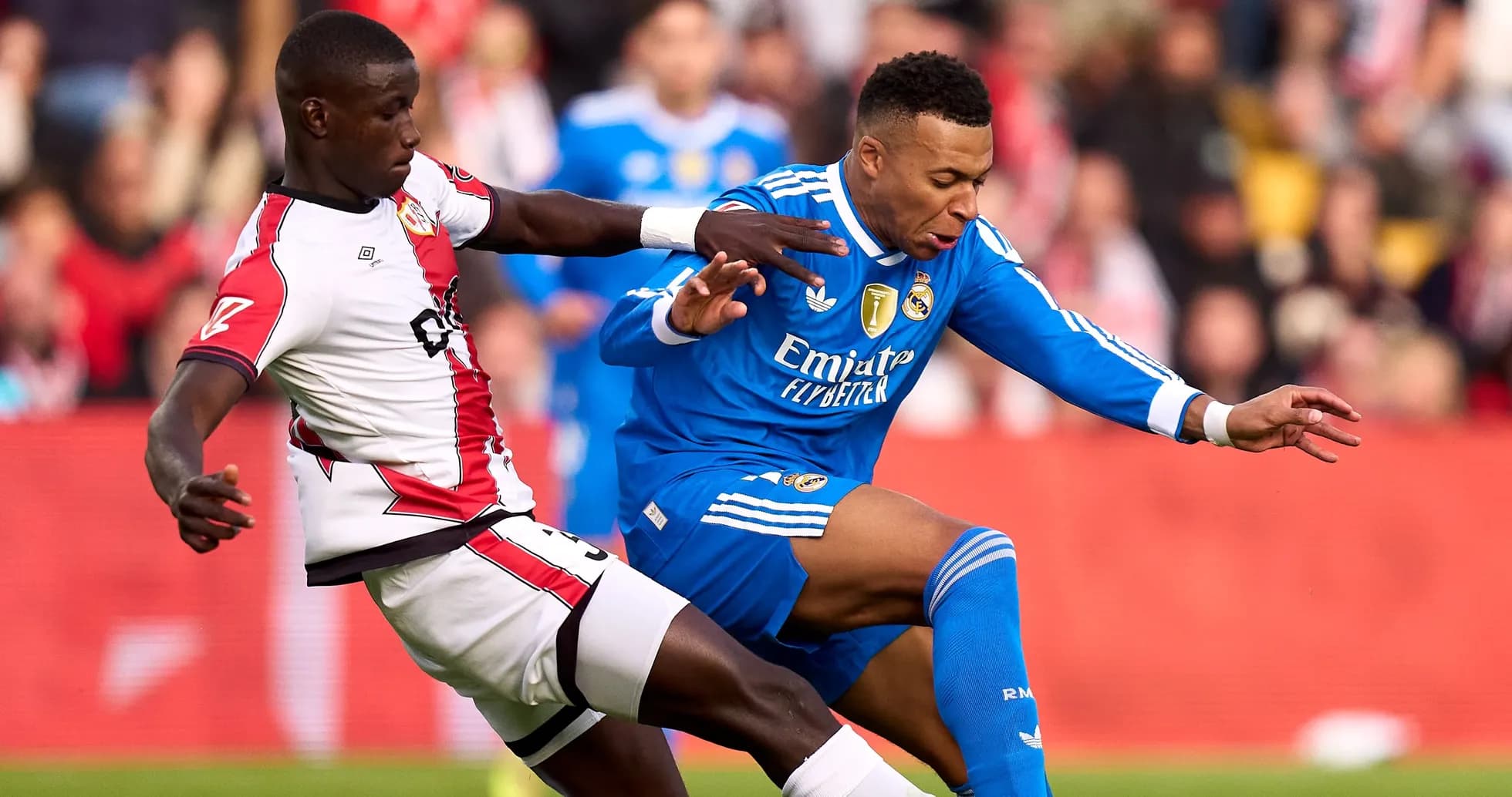 Player from Real Madrid being challenged by opponent