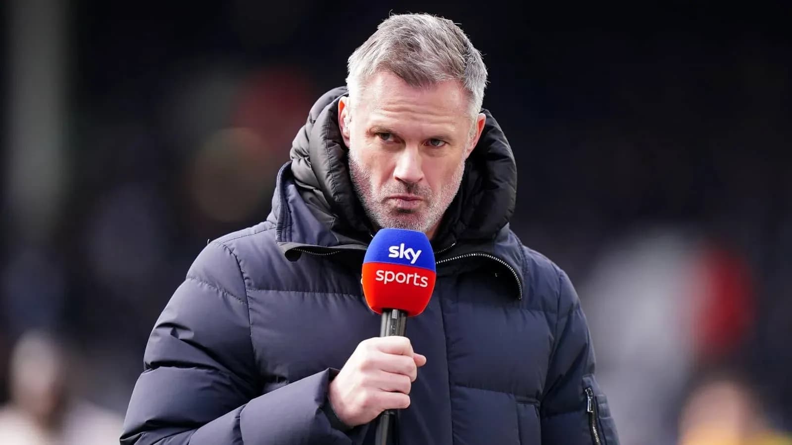Sportscaster speaking into microphone during broadcast
