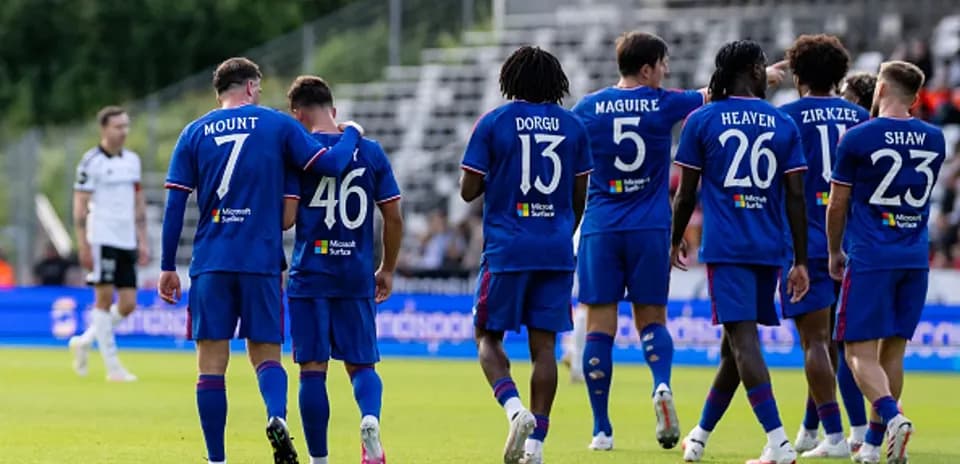 Players celebrating together on the field after scoring