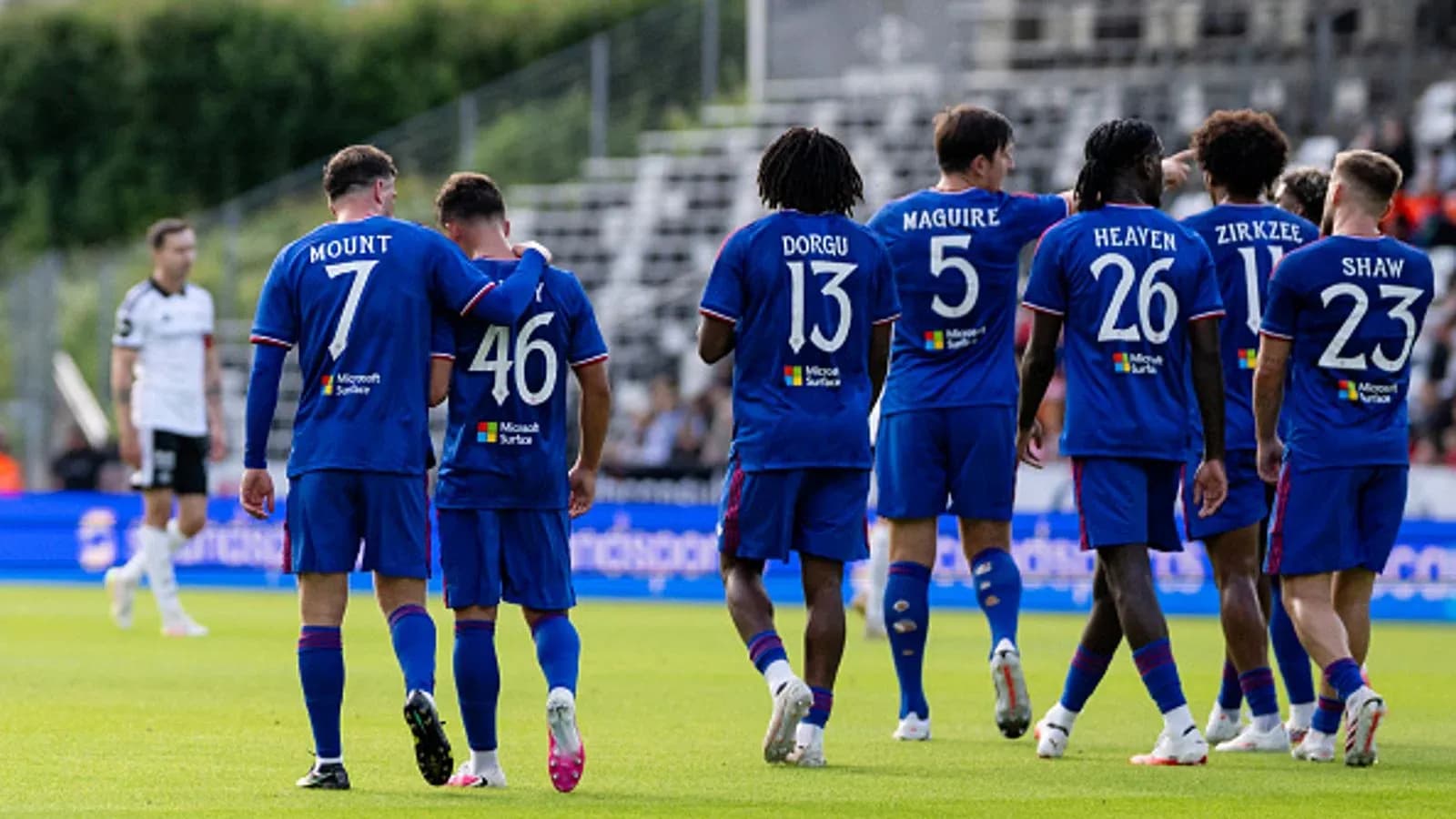 Players celebrating together on the field after scoring
