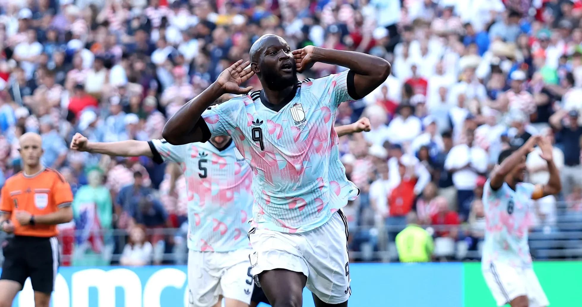 Player celebrating goal with hands on ears