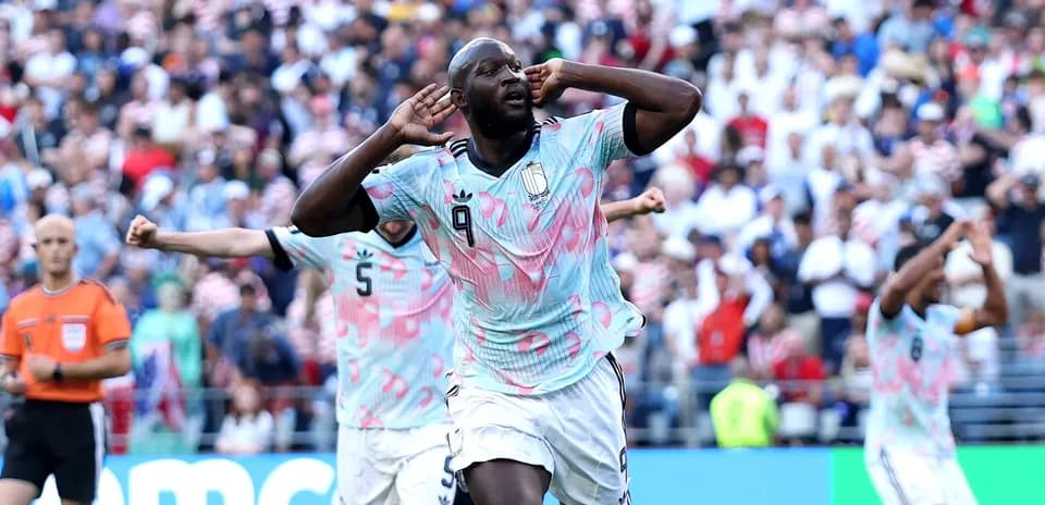 Player celebrating goal with hands on ears