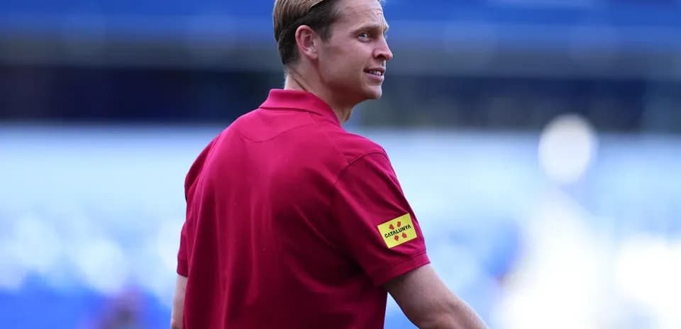 Official in red shirt during match preparations