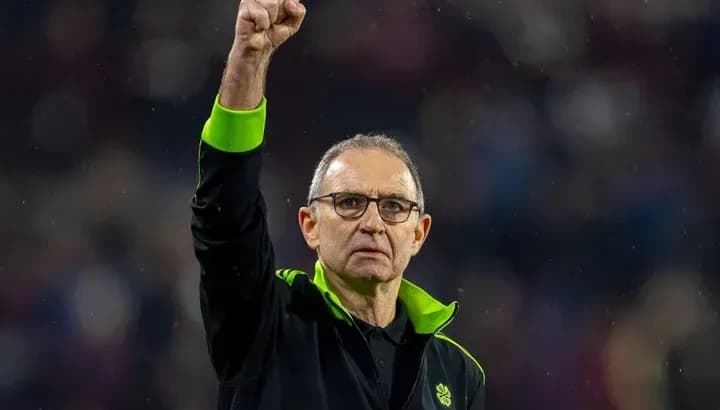 Coach gesturing with raised fist after match