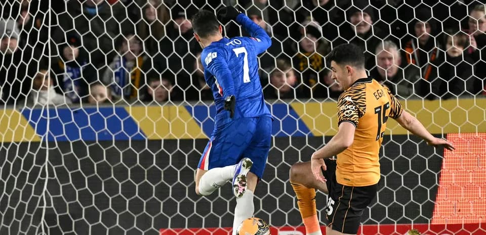 Chelsea player attempting to score against Hull City