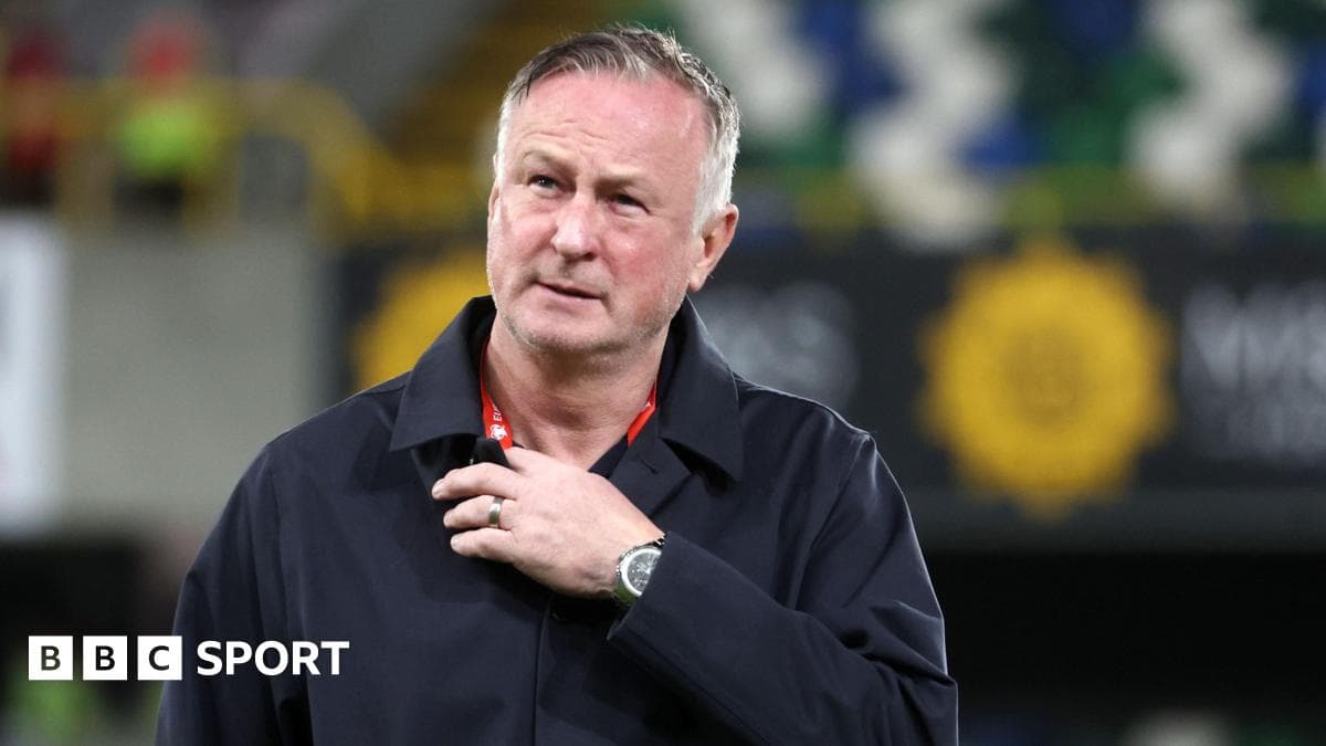Manager walking on the pitch during match