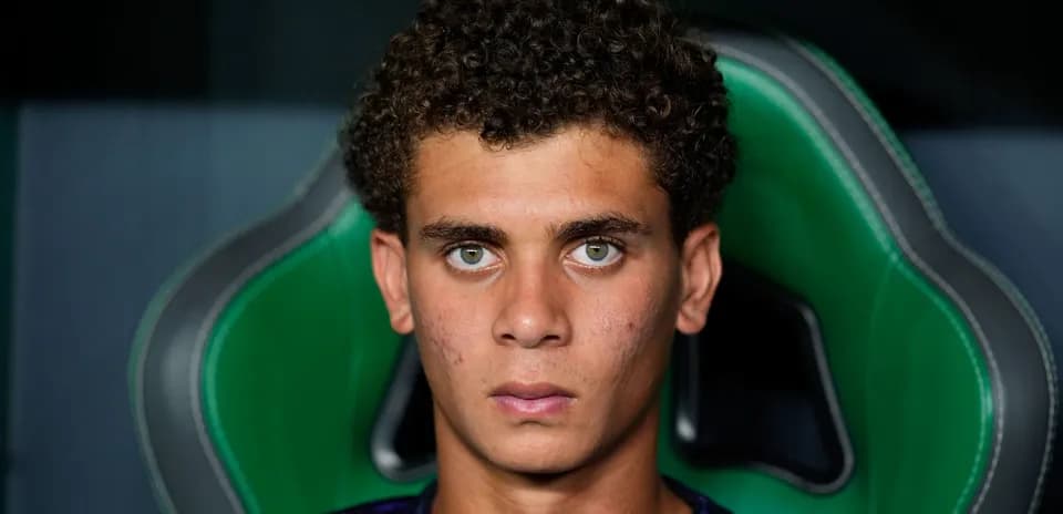 Young player sitting on a green gaming chair