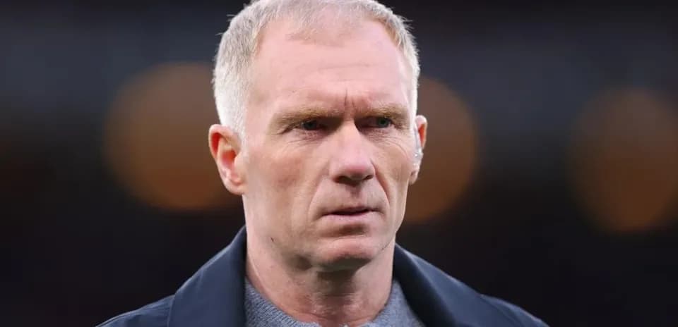 Man with short hair looking serious outdoors