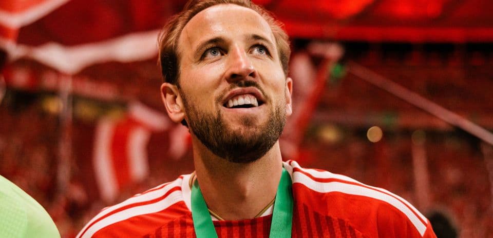 Player celebrating with medal and red background