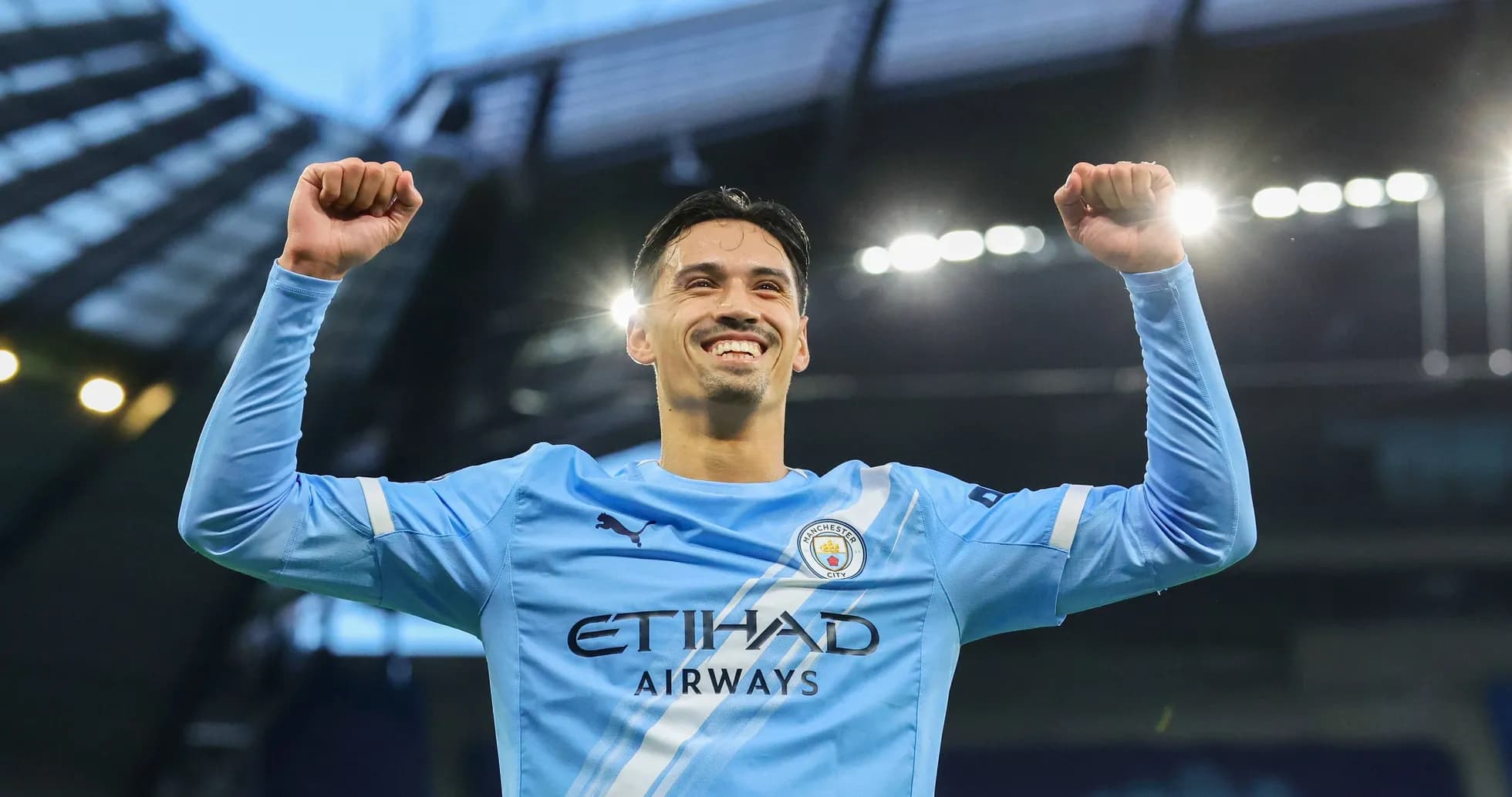 Player celebrating victory at stadium with raised arms