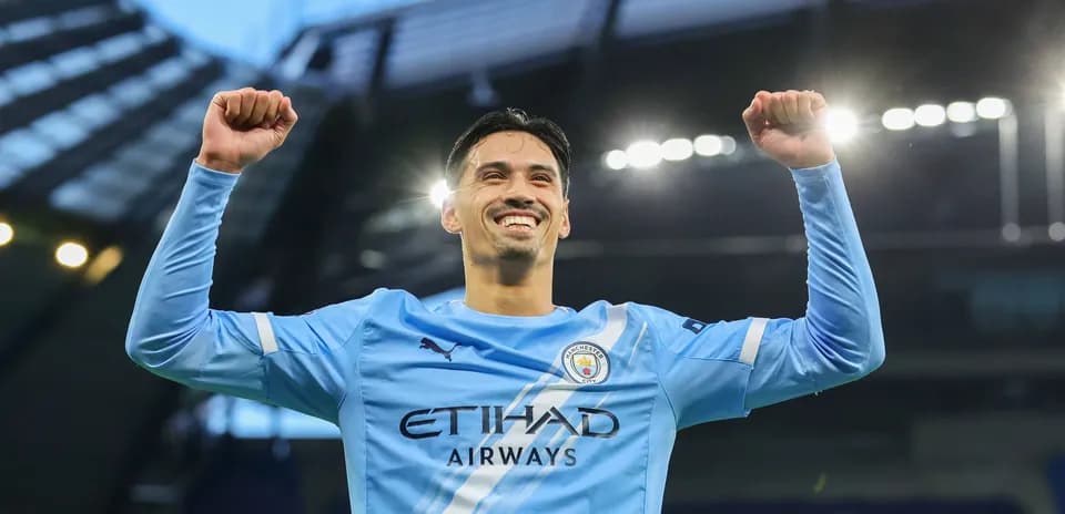 Player celebrating victory at stadium with raised arms