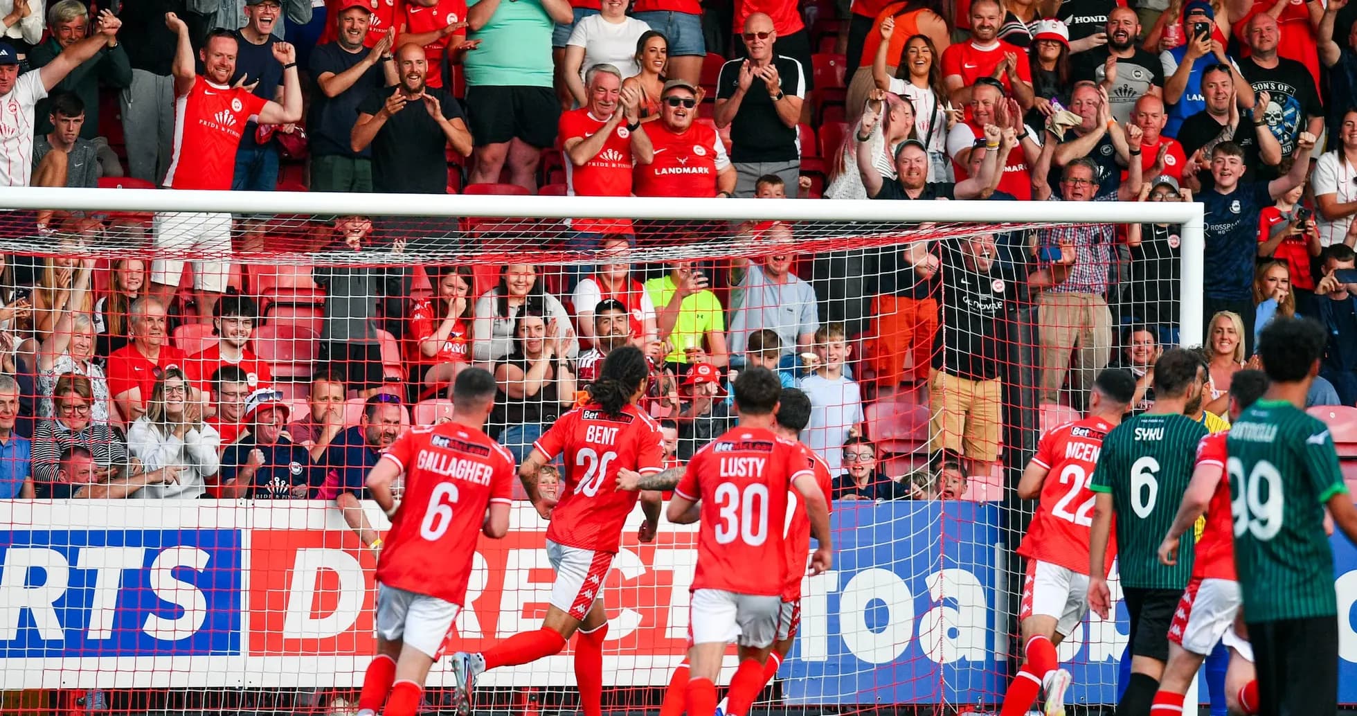 Larne players celebrating a goal against FK Crvena Zvezda