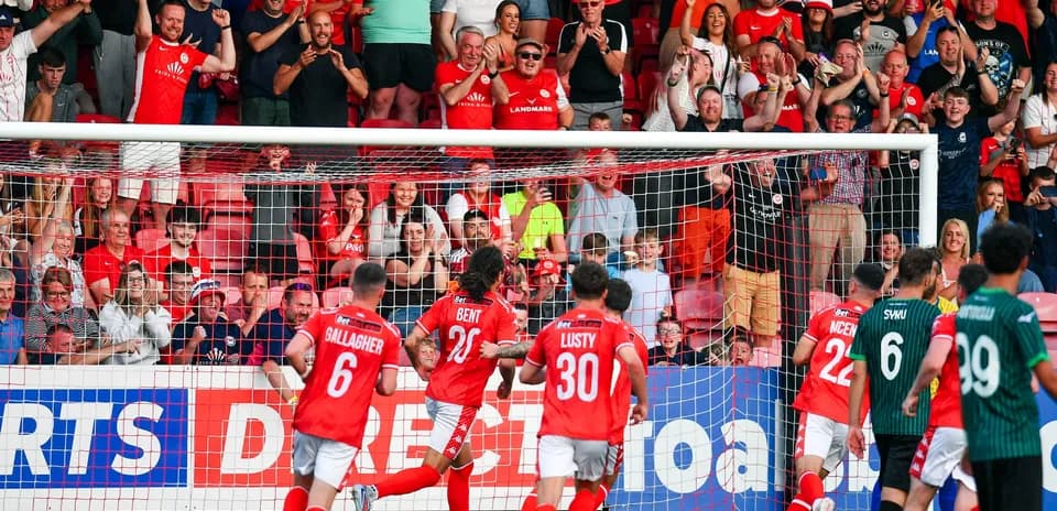 Larne players celebrating a goal against FK Crvena Zvezda