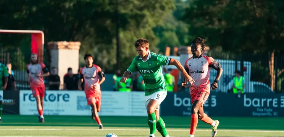 Player dribbling the ball during football match