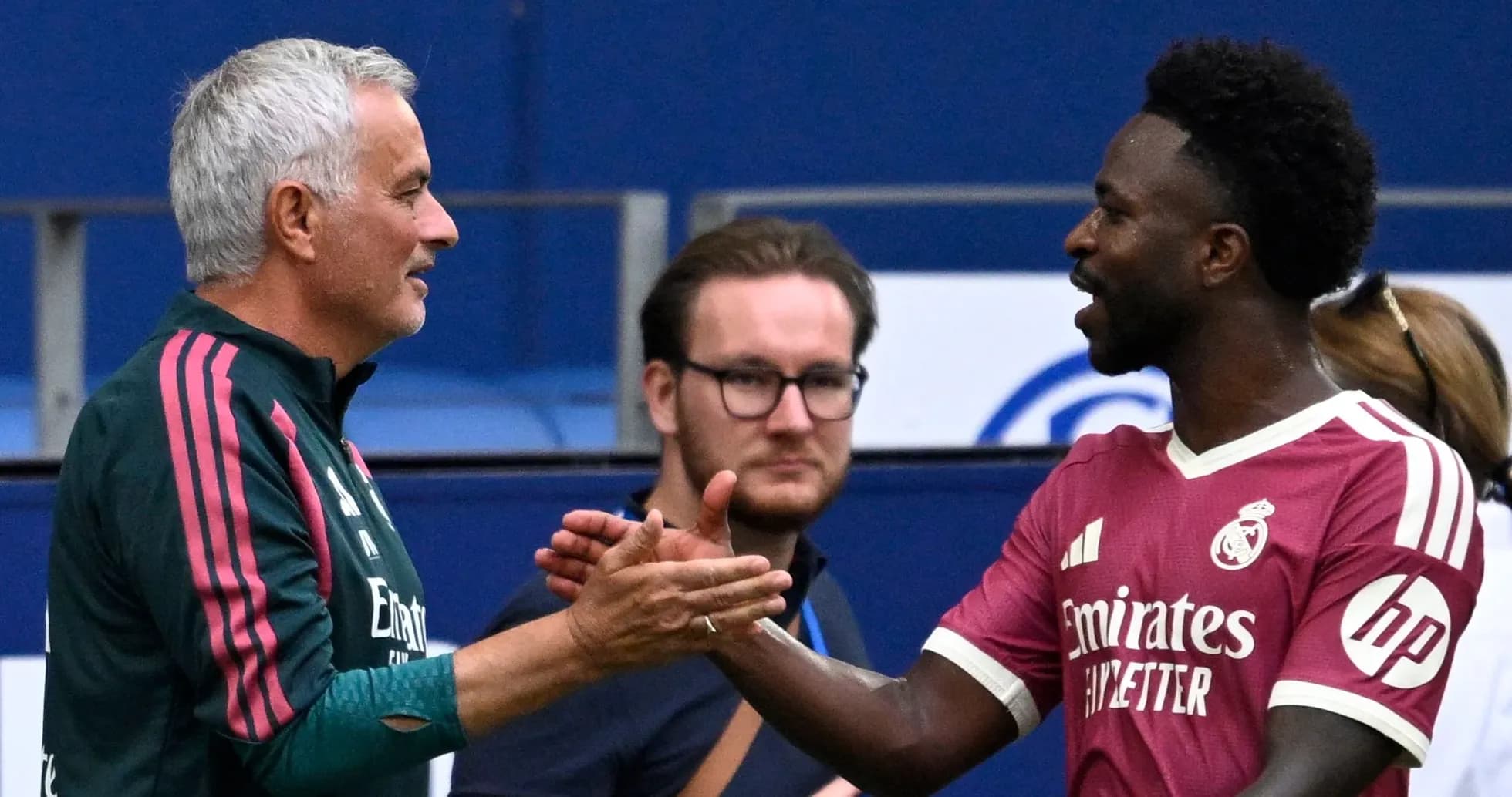 Coach and player shaking hands during match
