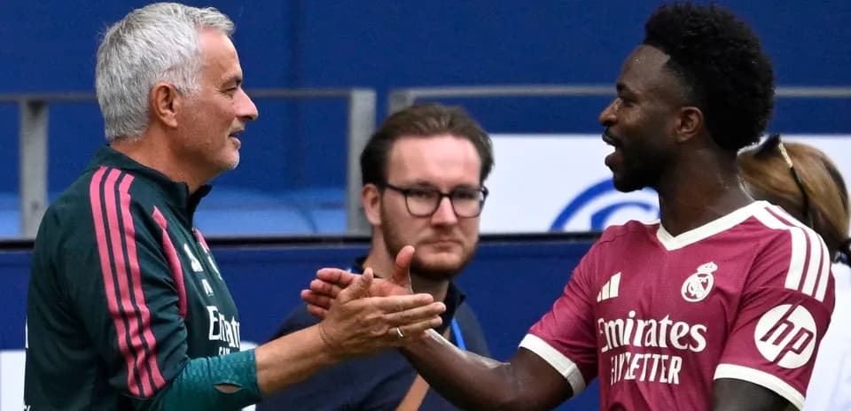 Coach and player shaking hands during match