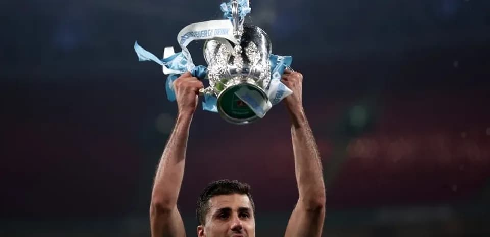 Player lifting trophy with blue ribbons after victory