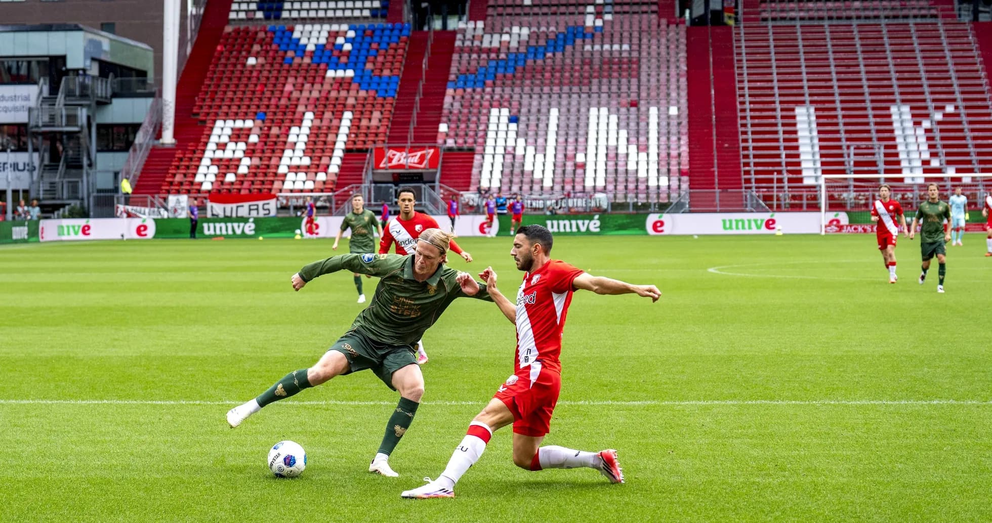 Two players competing for the ball on field