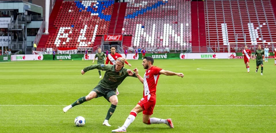Two players competing for the ball on field