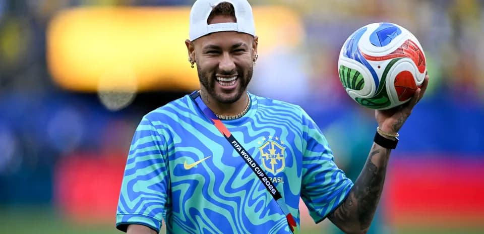 Player holding a soccer ball in team jersey